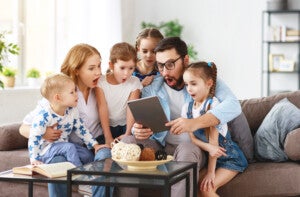 large family mother, father and children with tablet computer at home ALARMA